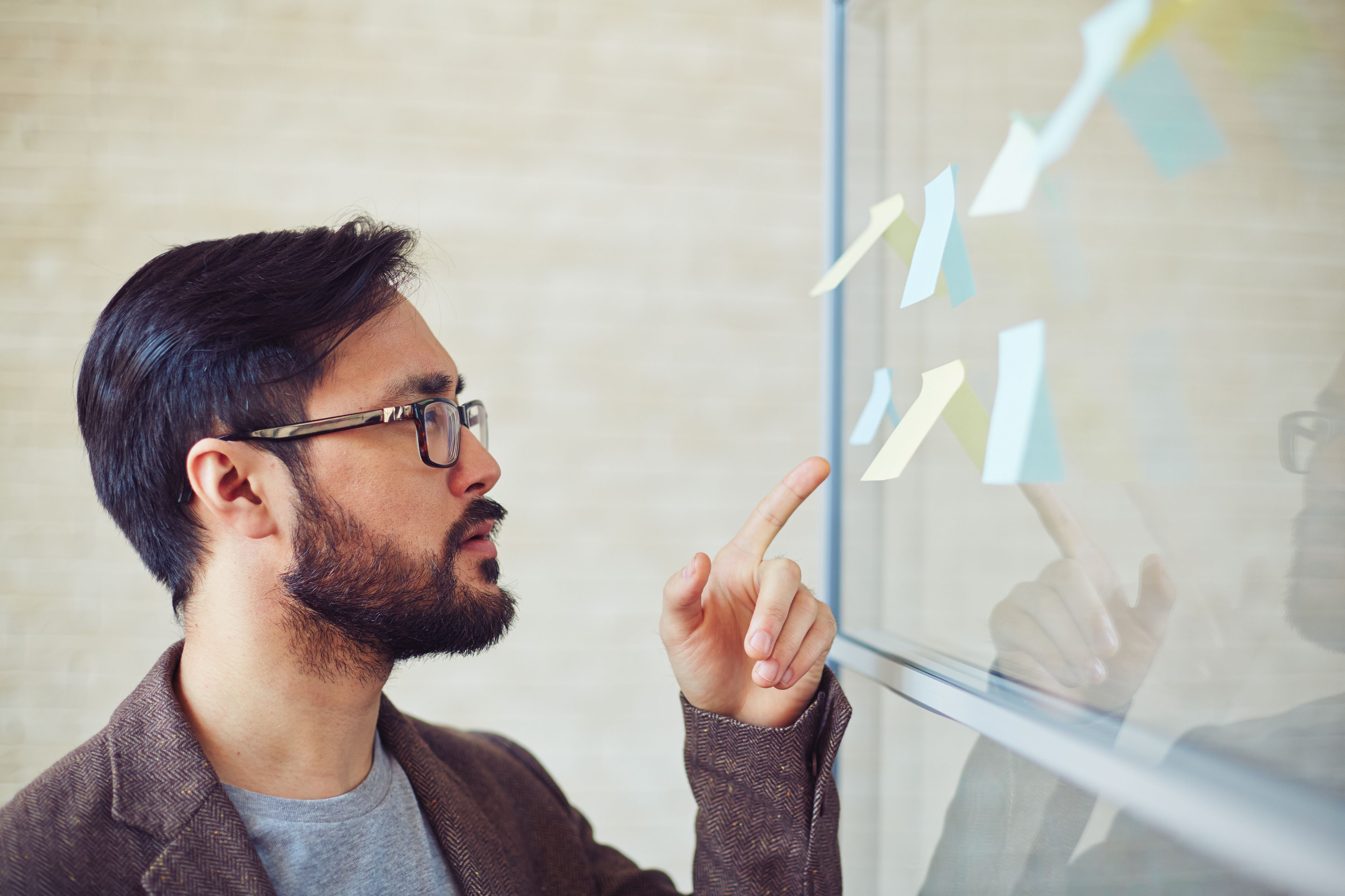 Young Modern Businessman Pointing At Reminder On Board