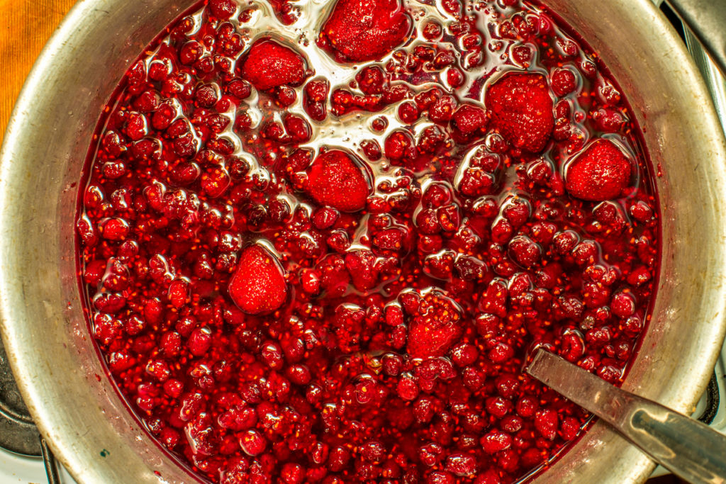 Large bowl of fresh jam being made
