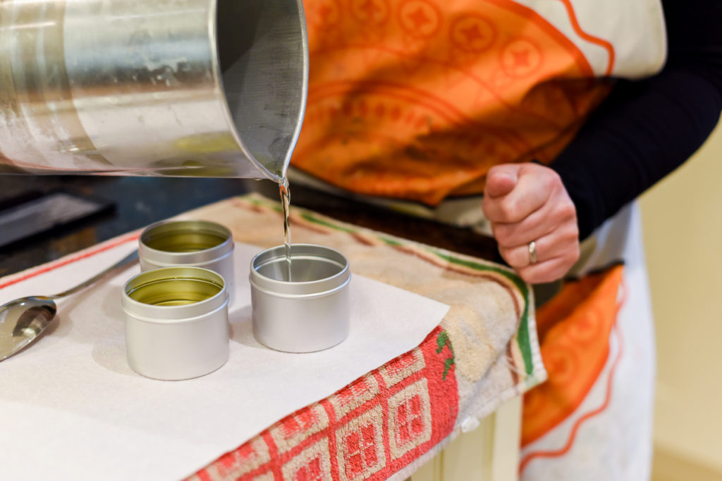 Pouring of liquid wax into jars