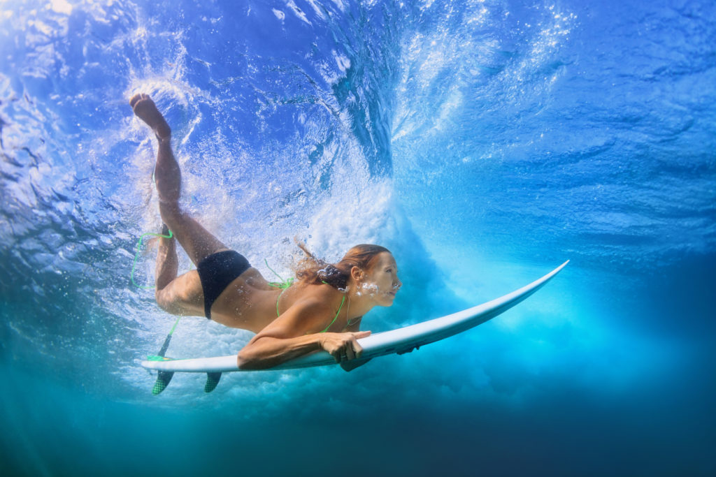 Surfer Duck Diving under a wave