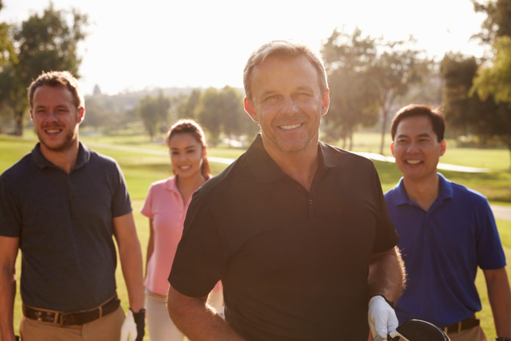 Golfers Walking Along Fairway