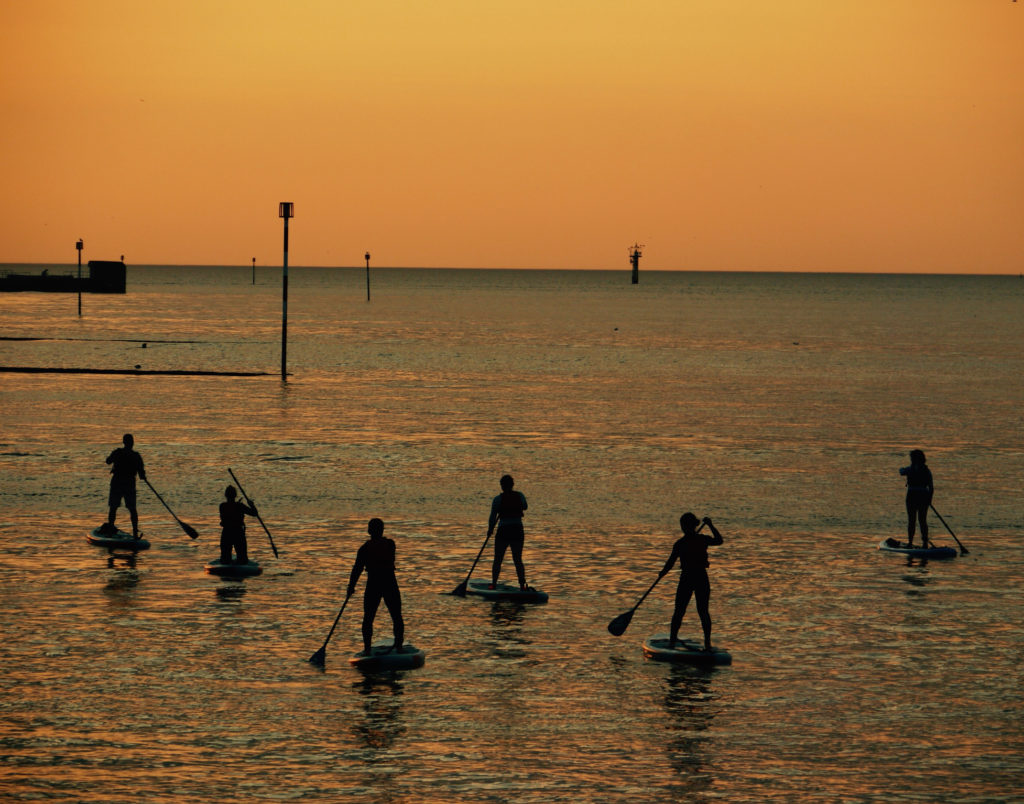 Stand-Up Paddle Boarders at Sunset